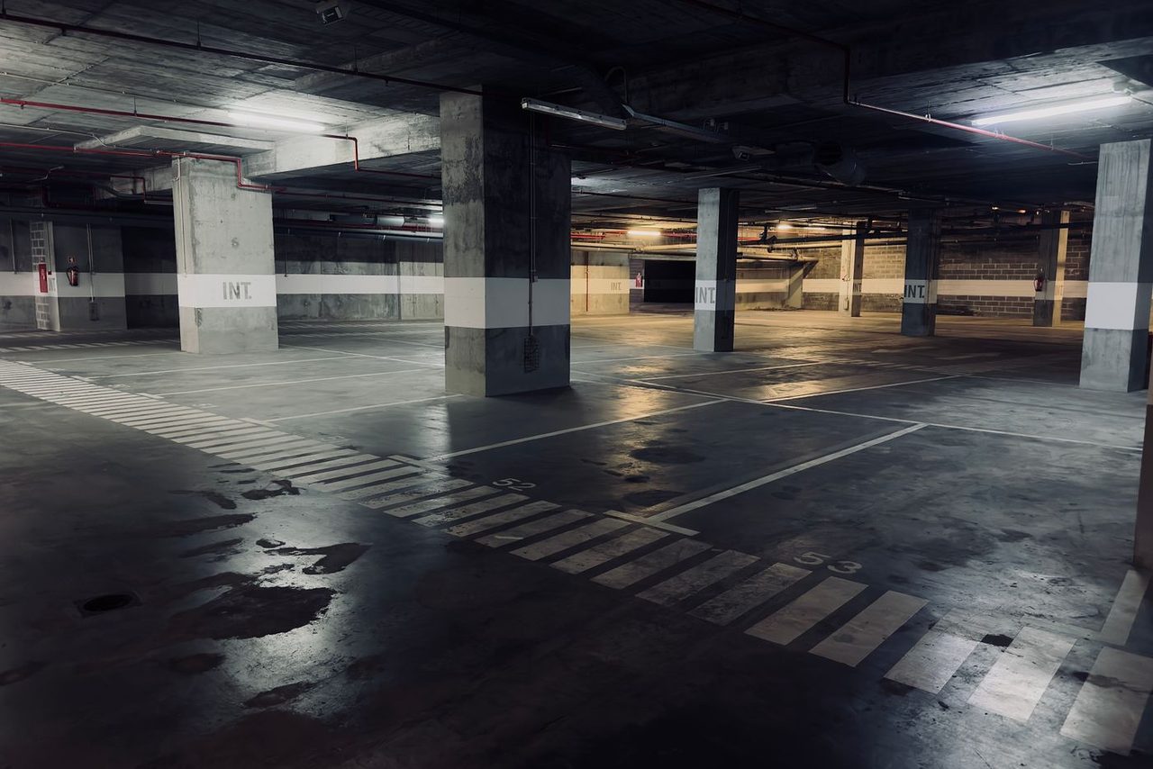 Stained and worn commercial parking deck before coating