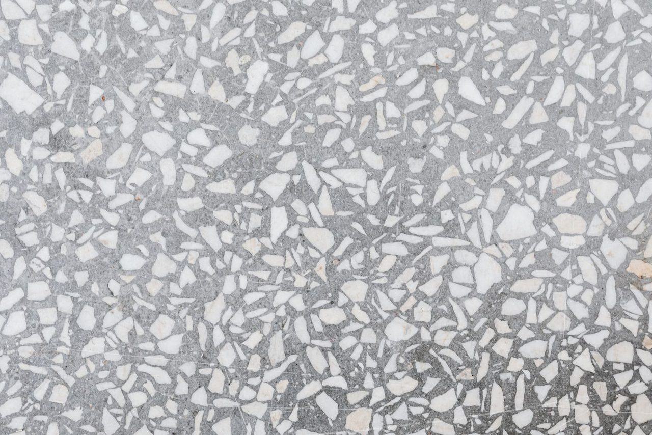 Close-up of a gray, white and blue full-broadcast flake epoxy floor finish
