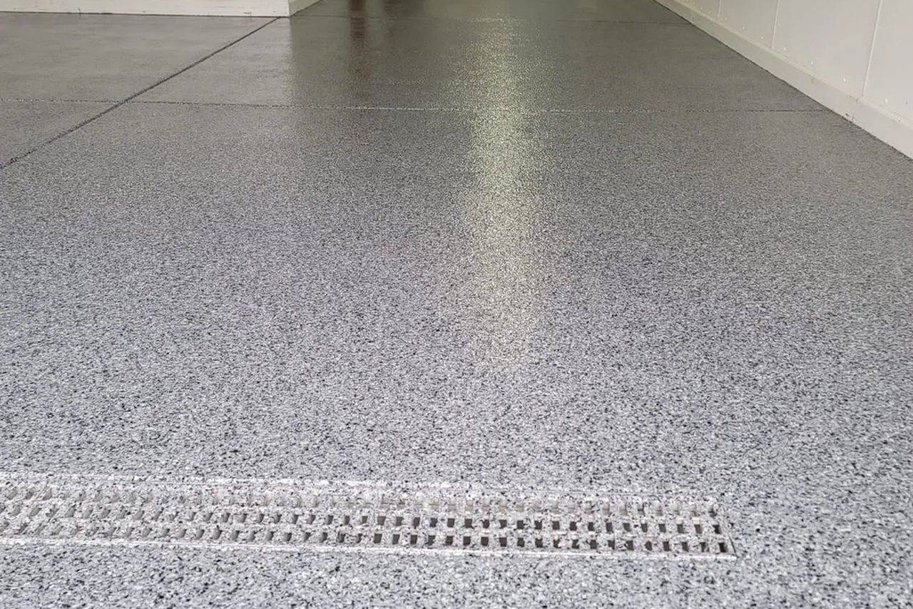 Finished garage floor with a flake epoxy coating, installed by DP Flooring Services