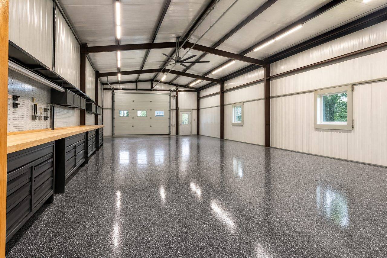 Workshop interior with a dark gray flake epoxy floor running the length of the building