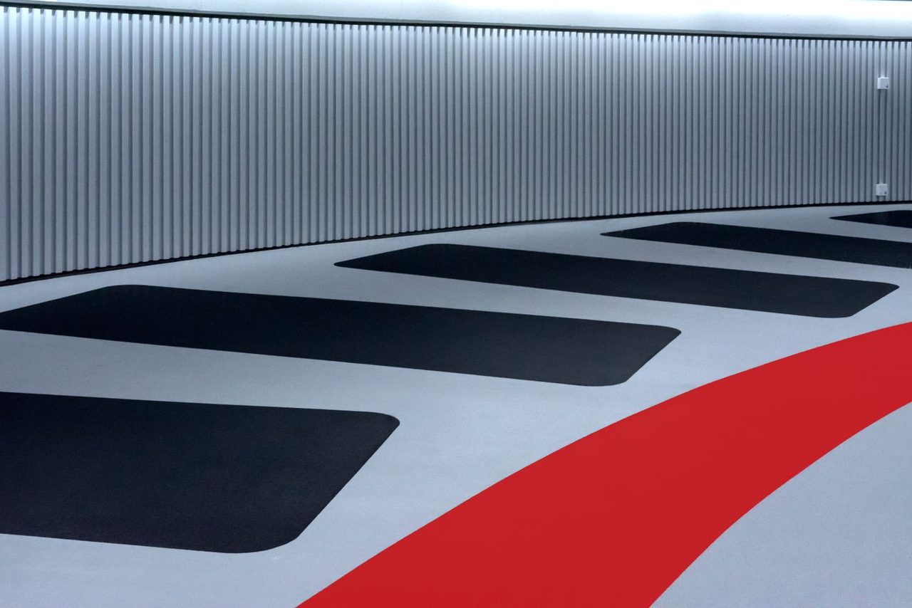 Coated showroom floor with black and red inlaid graphics